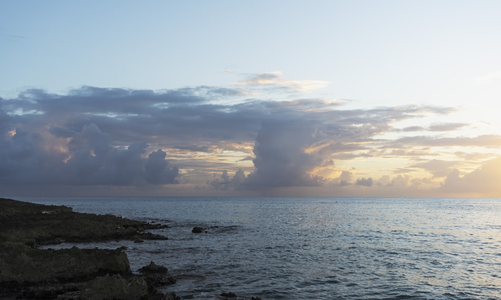 a large body of water sitting under a cloudy sky