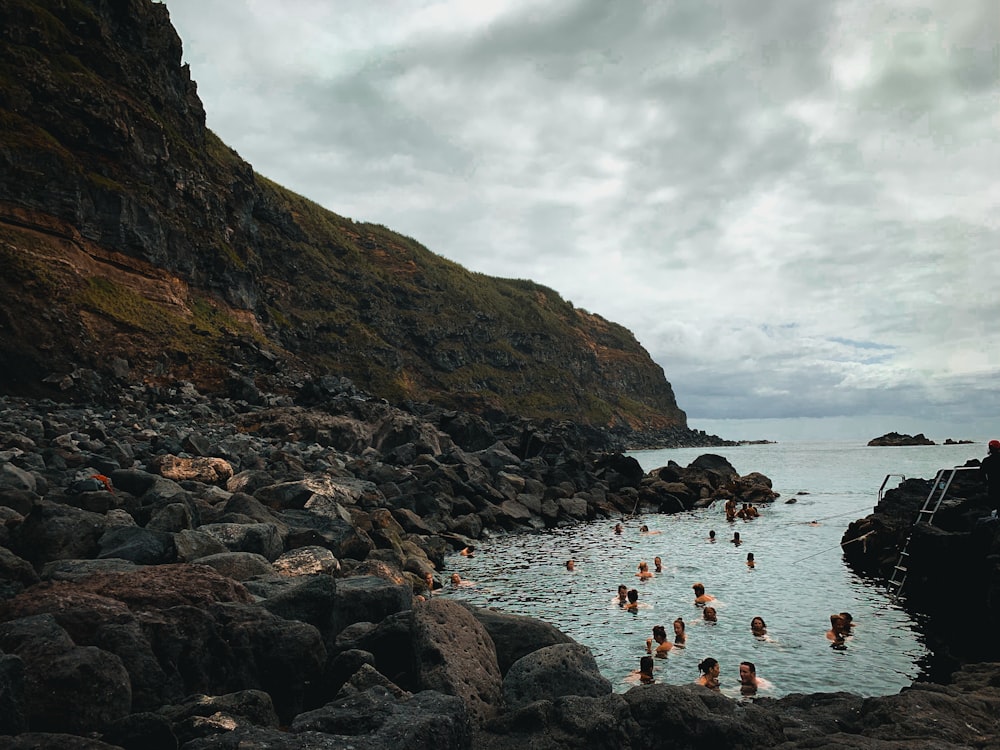 group of people swimming in the lake