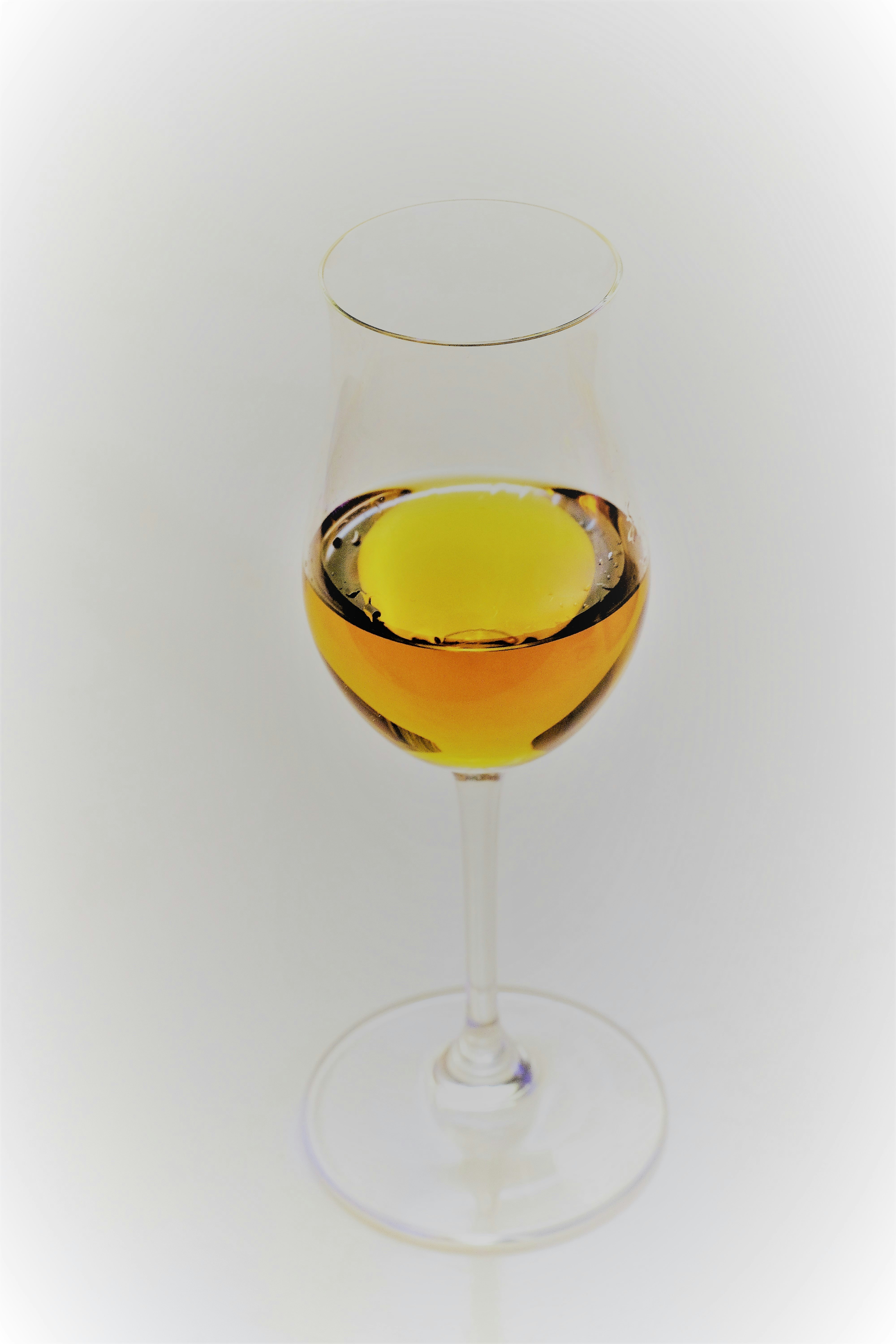 Download Clear Glass Bottle With Yellow Liquor Photo Free Glass Image On Unsplash Yellowimages Mockups