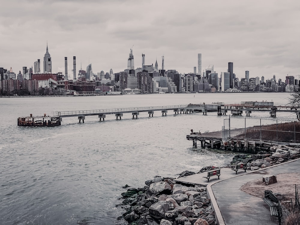 city buildings and dock near body of water