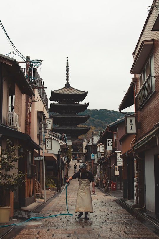 man watering floor in Yasaka Shrine Japan