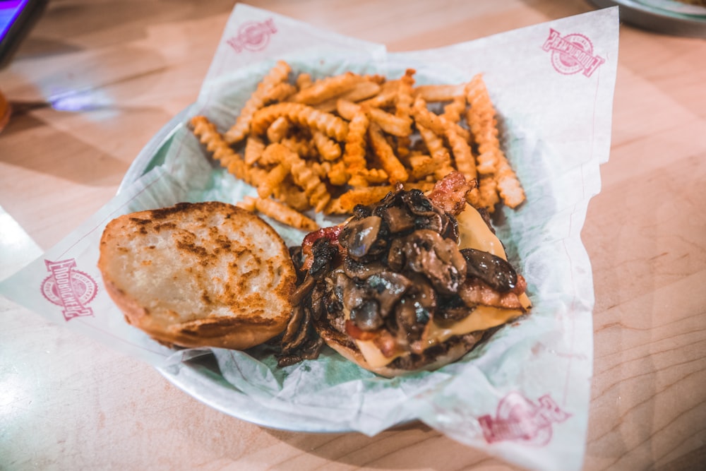 burger and potato fries on plate