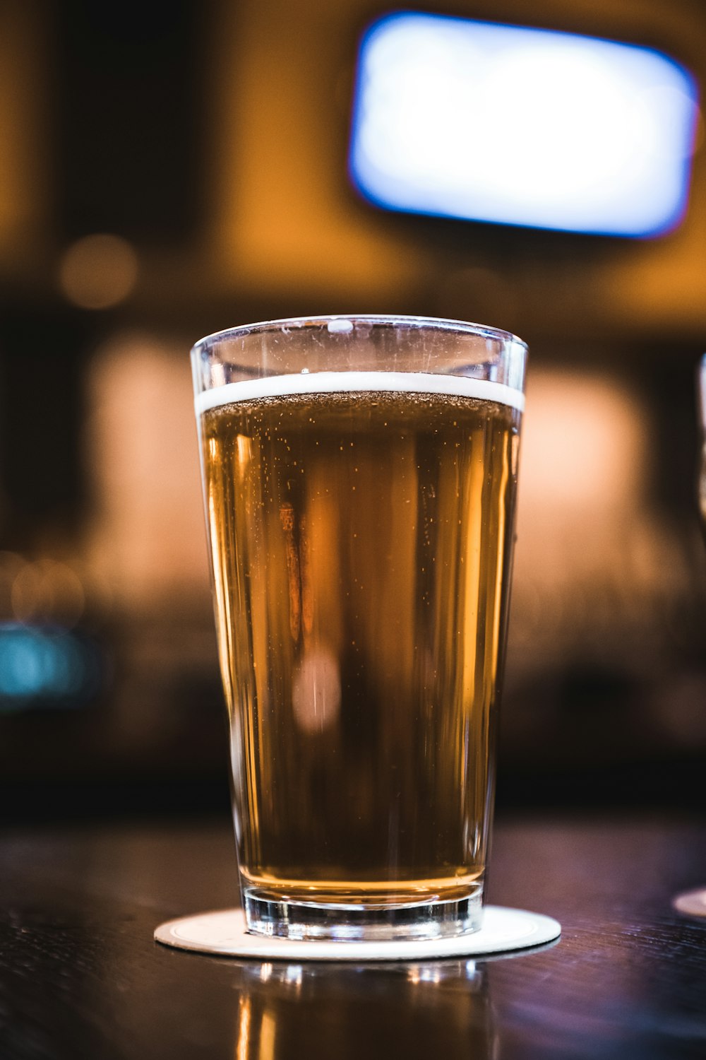 clear drinking glass filled with yellow liquid