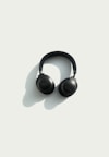 black JBL corded headphones on white panel
