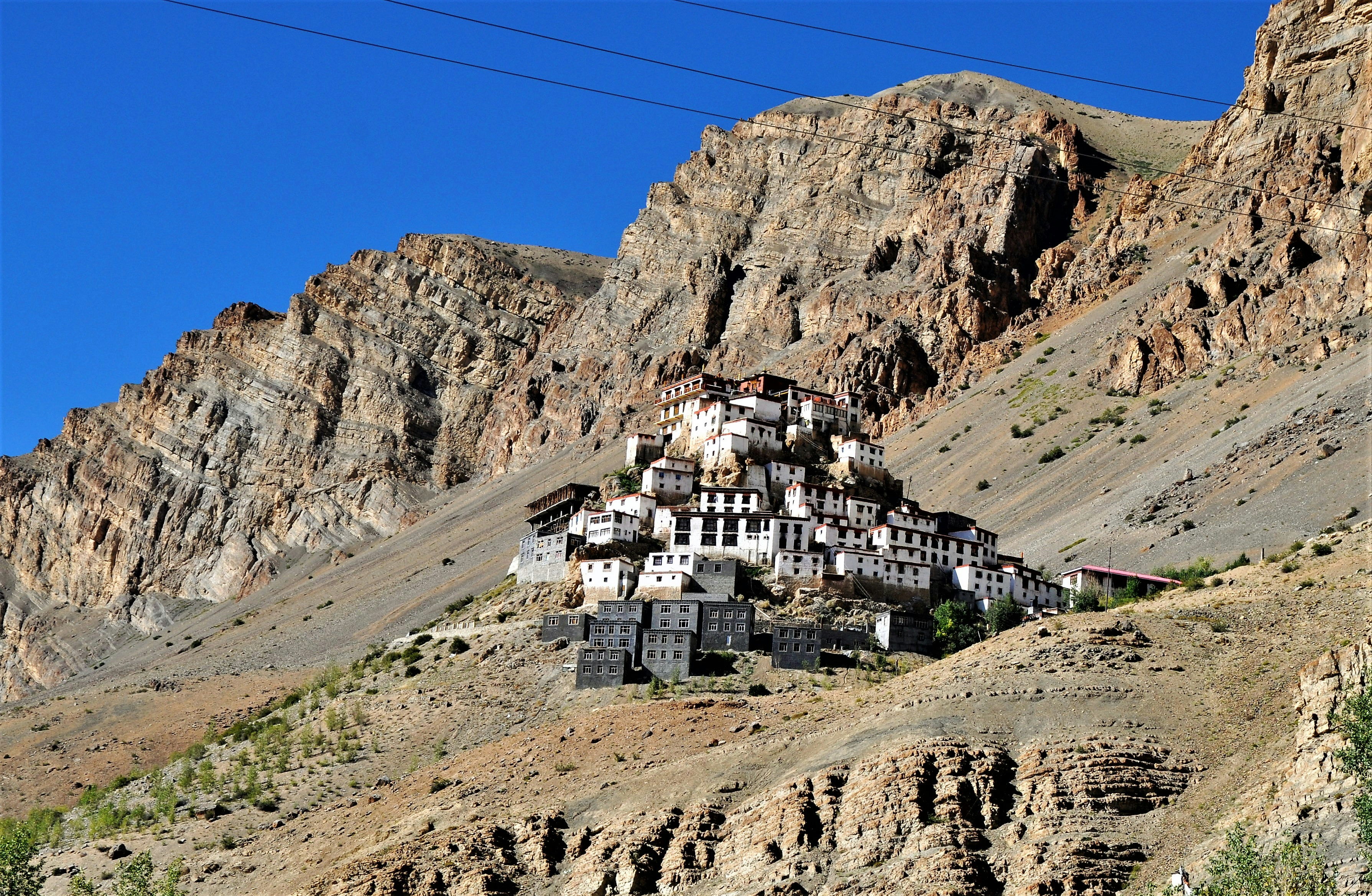 Overlooking Kaza from a height of 13,500 ft, the Kye monastery is the largest in the valley & holds a powerful sway over the most populous part of the valley around Kaza. The gompa is an irregular heap of low rooms & narrow corridors on a monolithic conical hill. From a distance is resembles the Thiksey monastery near Leh in Ladakh. The irregular prayer chambers are interconnected by dark passages, tortuous staircases and small doors. Hundreds of lamas receive their religious training in the monastery. It is also known for its beautiful murals, thankas, rare manuscripts, stucco images etc.