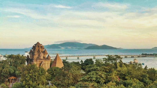 brown rock formation surrounded with trees near seashore in Nha Trang Bay Vietnam