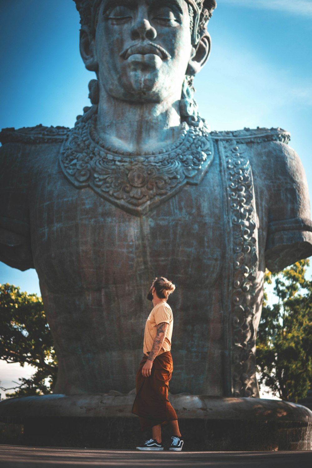 man standing in front of statue