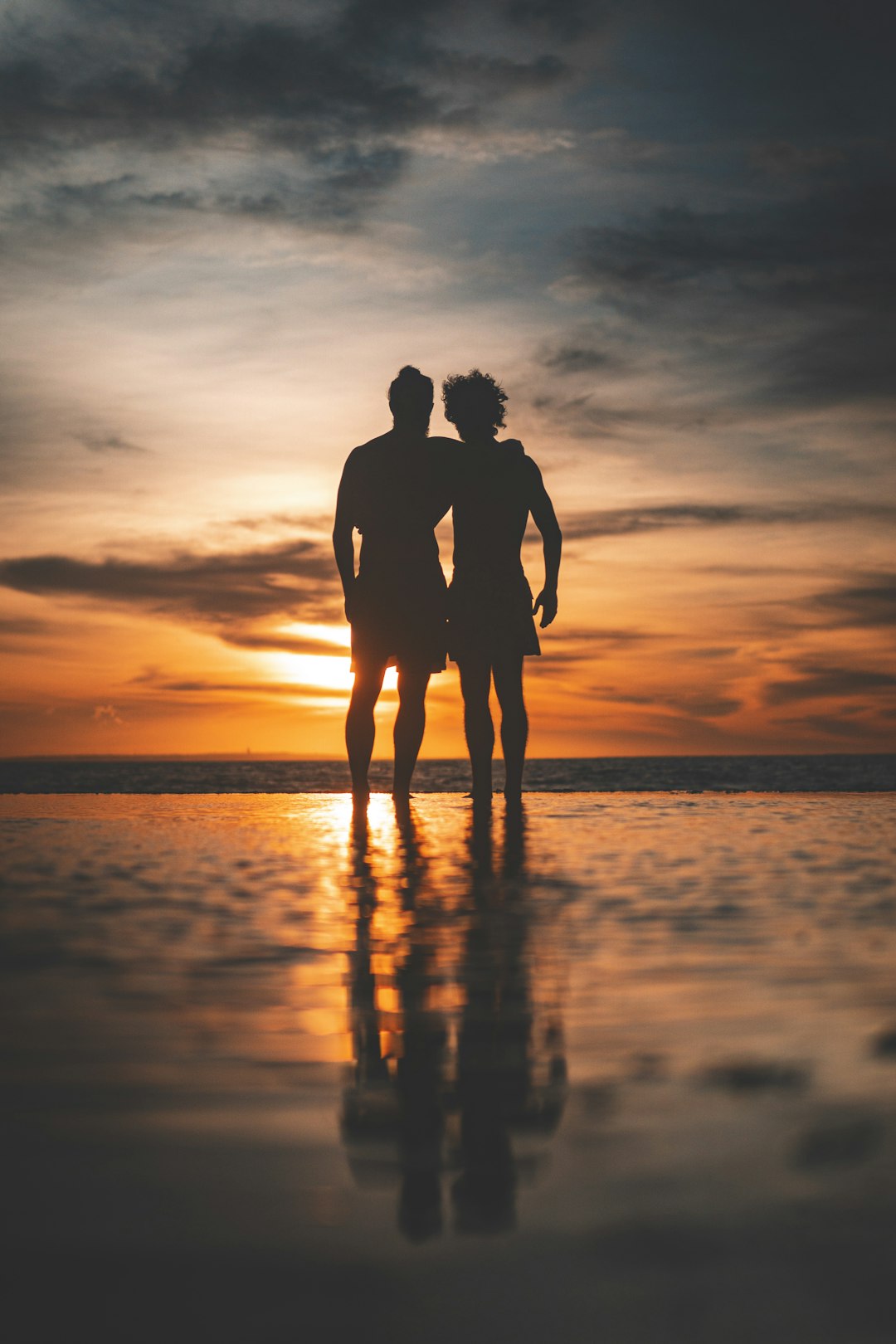 silhouette of men on beach