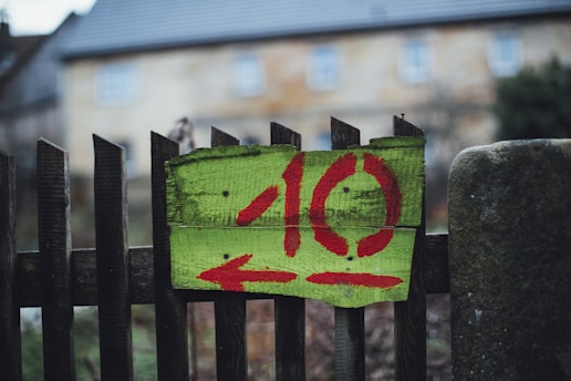a wooden fence with a painted sign on it