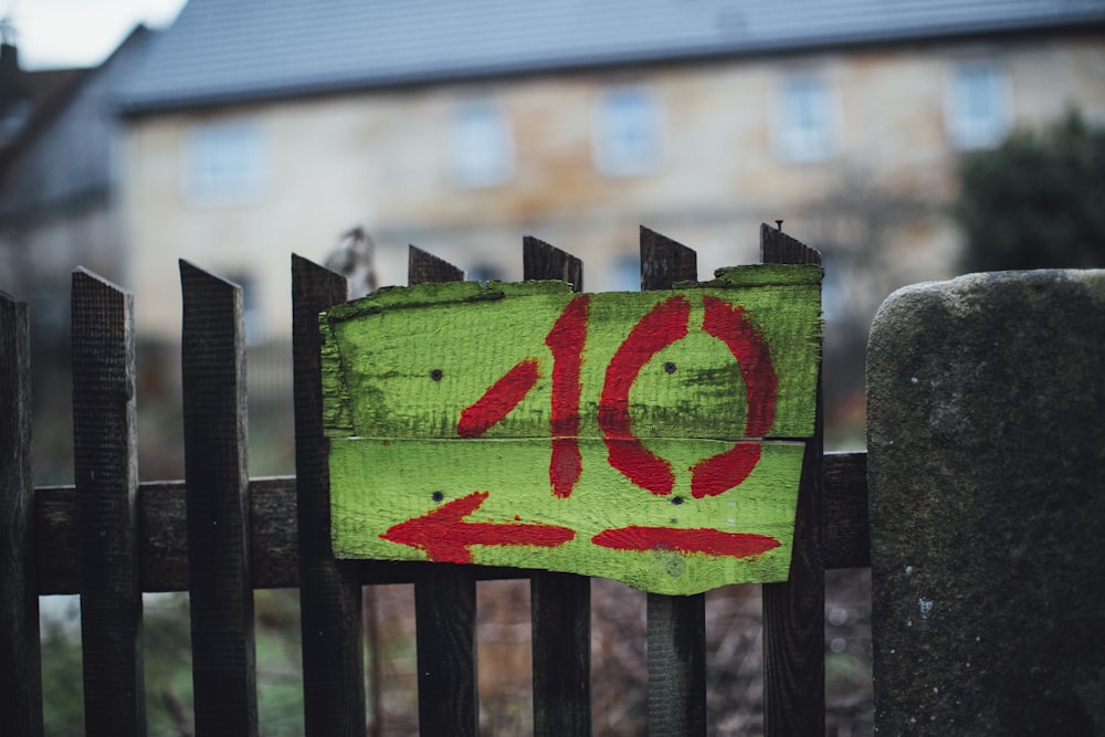 a wooden fence with a painted sign on it