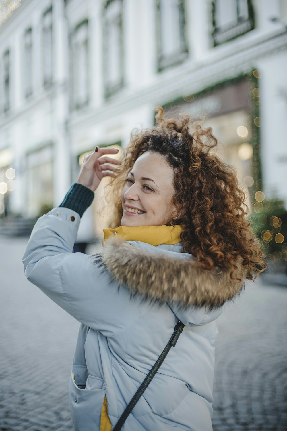 smiling woman wearing grey parka jacket