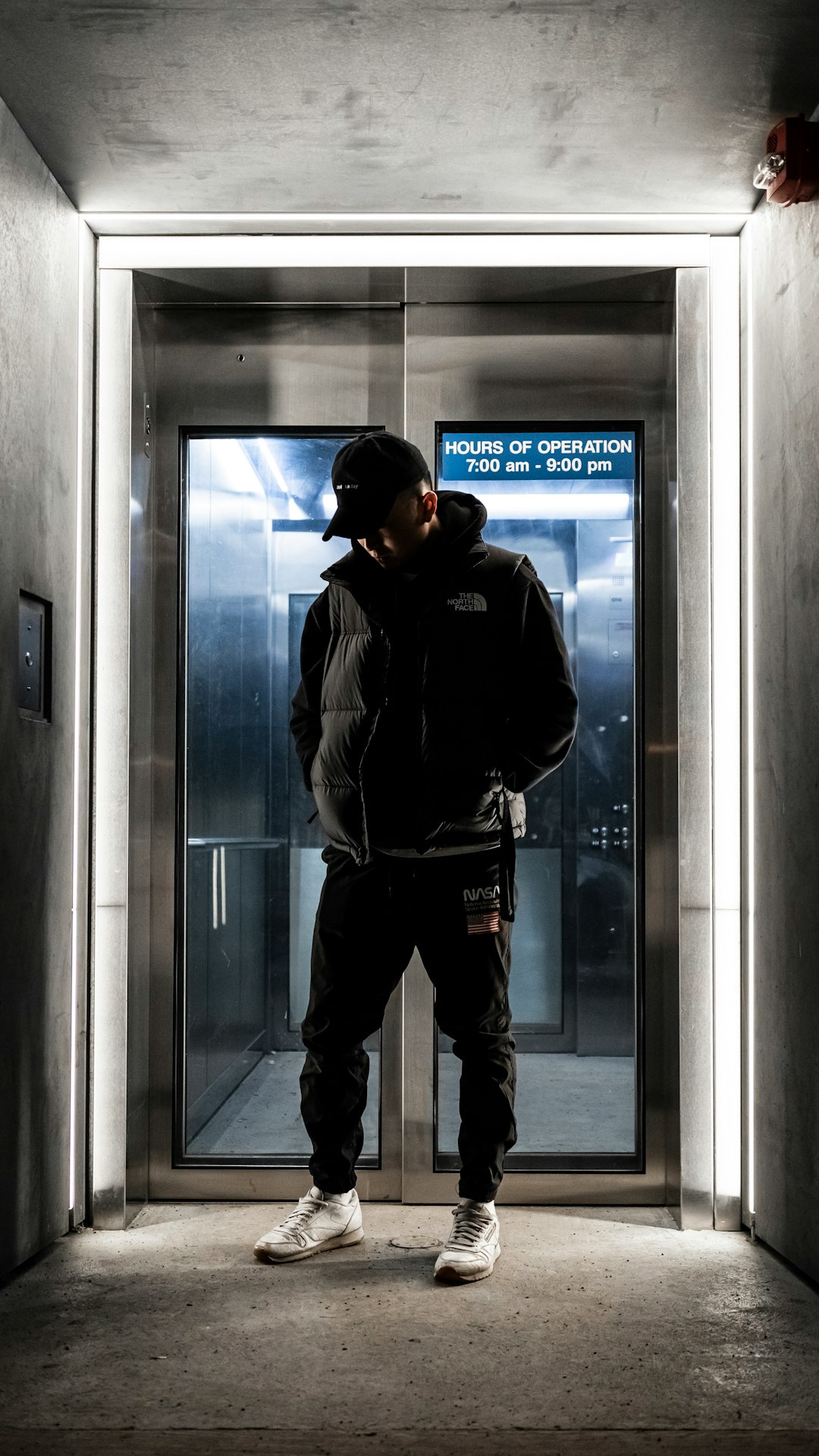 man standing in front of glass door