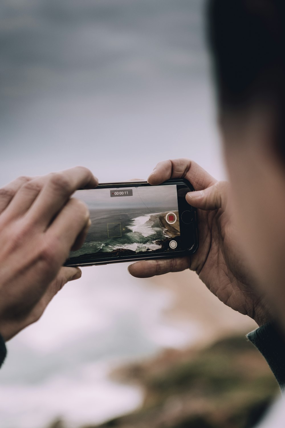 person holding space gray iPhone 6 displaying camera application