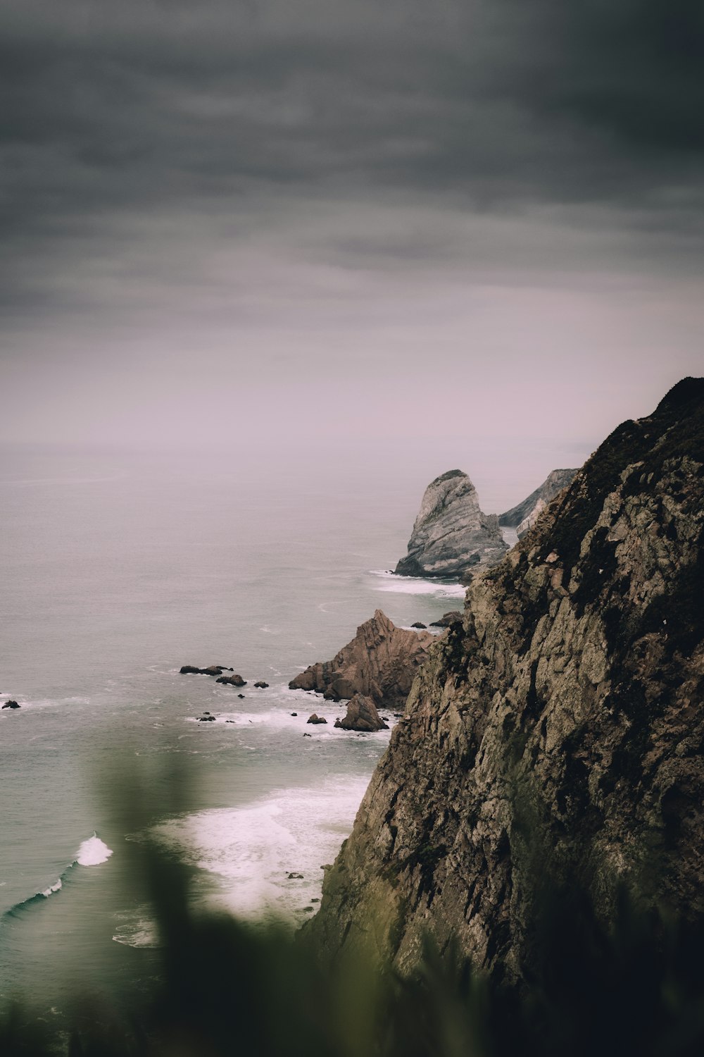 black and brown mountain range and cliff beside body of water