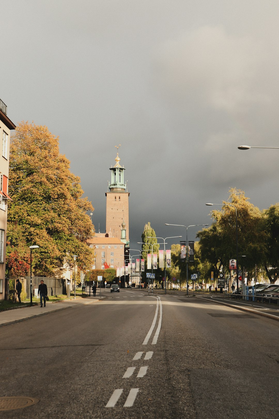 brown and white building and green trees