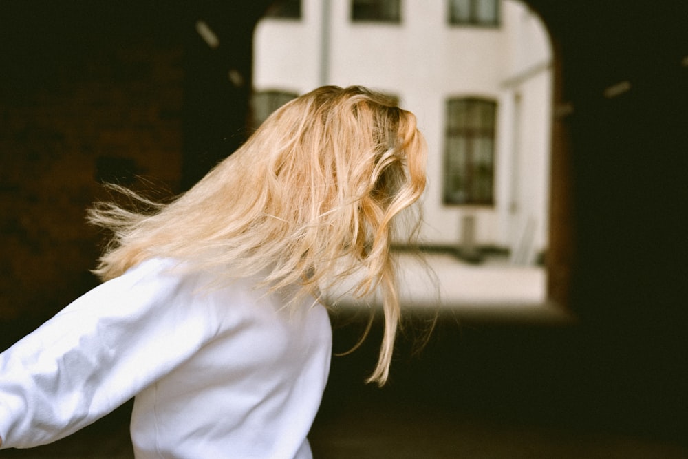 woman wearing white long-sleeved top