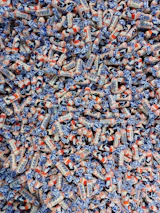 Smiling team members packaging vibrant candies with care and attention.