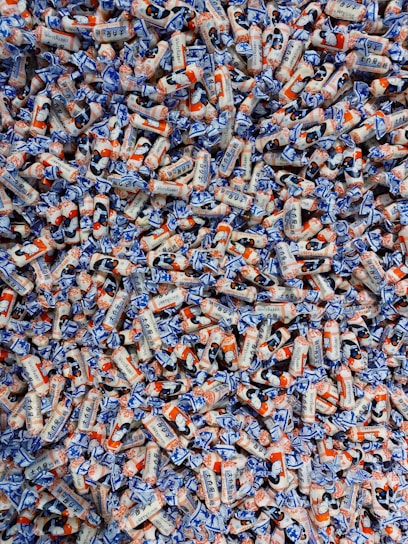 A close-up of glossy, wrinkle-resistant mylar bags filled with colorful candies and tied with festive ribbons.