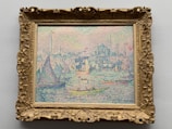 A colorful pointillist painting depicts boats on water with a city skyline in the background. The scene is filled with vibrant dots of color, creating a textured and dynamic effect. Sailboats with varying sail shapes and sizes can be seen on the water, and a bustling cityscape is visible in the distance.