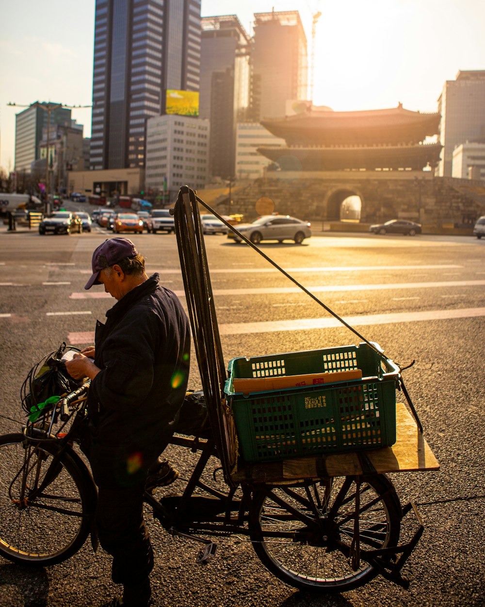 man standing beside the bicycle