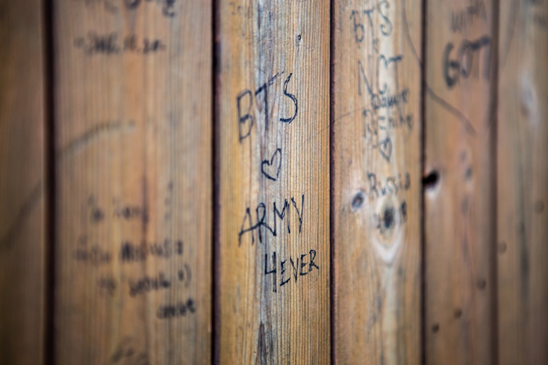 writings on wooden fence