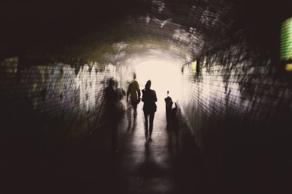 silhouette photography of people in tunnelt