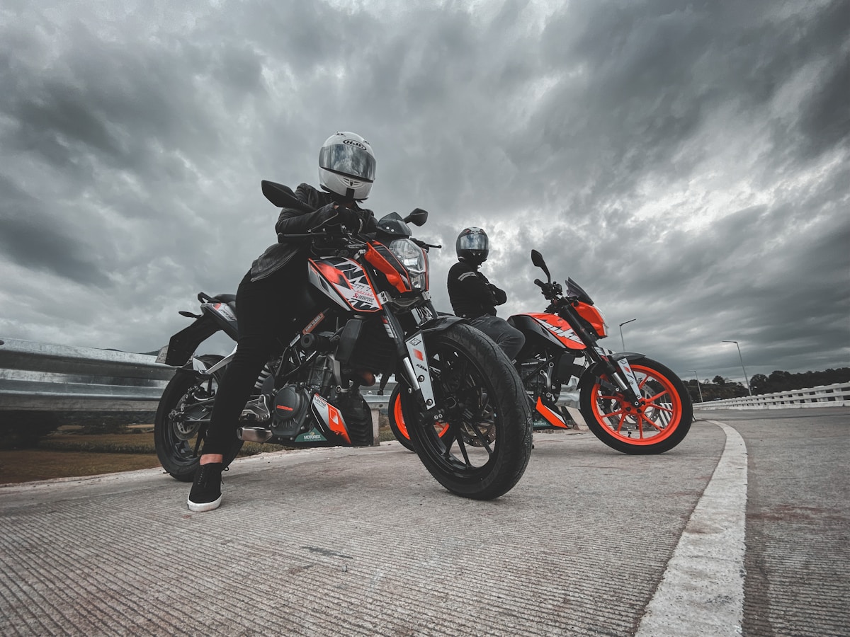 Sport touring motorcycles under a cloudy sky on a highway