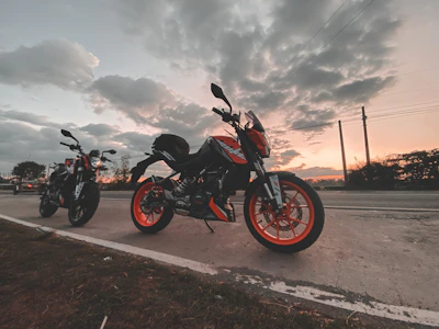 A sunset view of motorcycles lined up beside a cozy roadside tavern.
