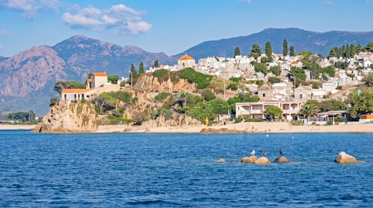 mountain with houses near sea during daytime in Korsika France