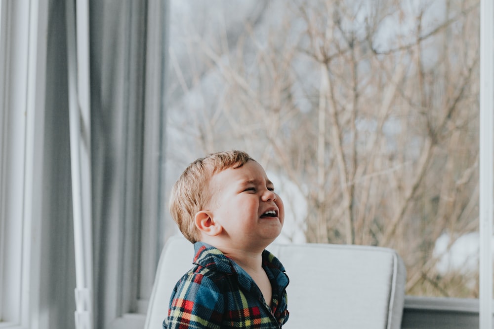 boy sitting near glass wall