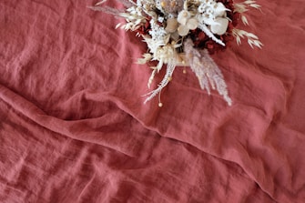 basket of flowers on red surface