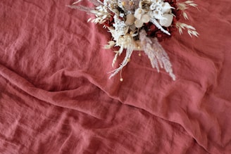 basket of flowers on red surface