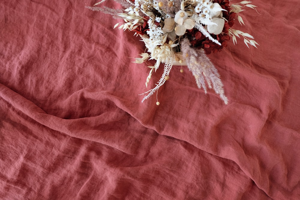 basket of flowers on red surface