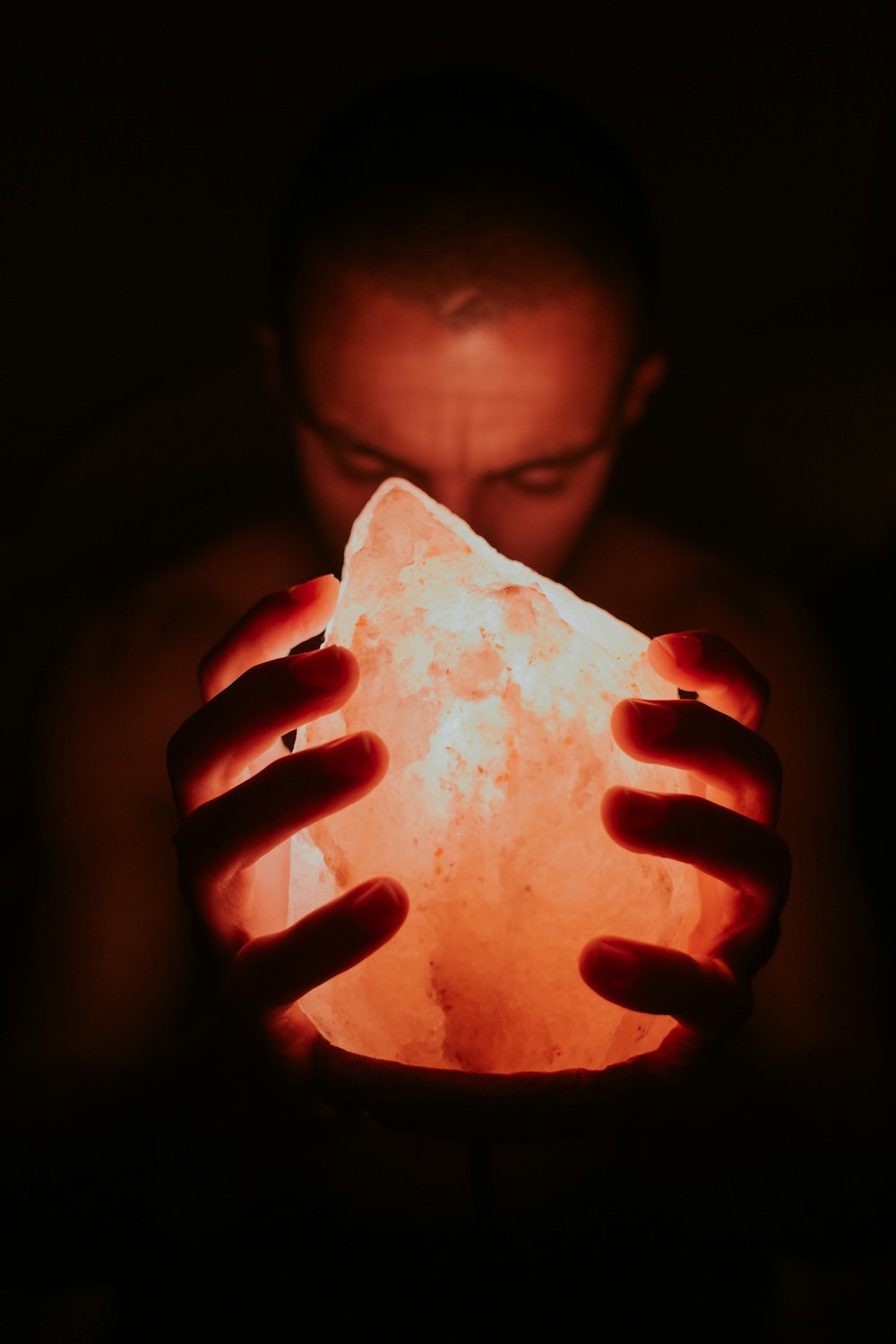 man holding Himalayan lamp