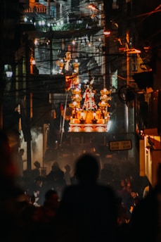 Nighttime view of the carnival procession illuminated by vibrant lights and festive floats.