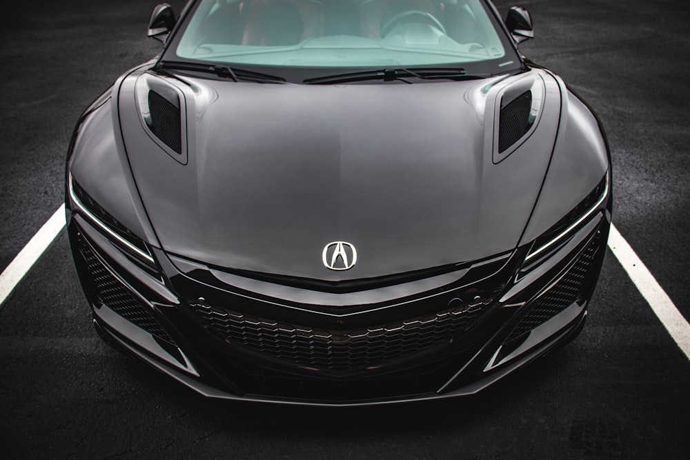 black Acura NSX coupe on paved road
