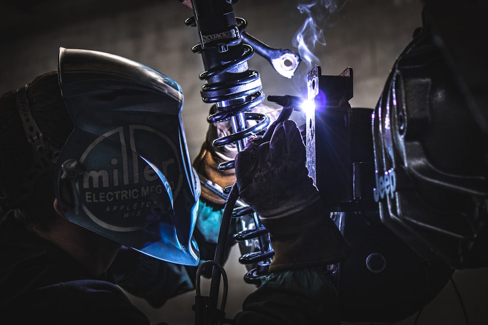 a man wearing a helmet and welding equipment