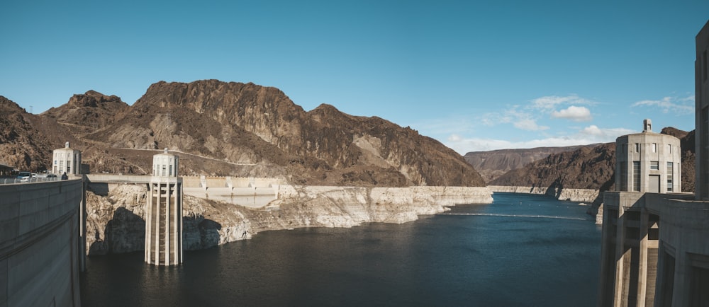 gray dam near mountains during day