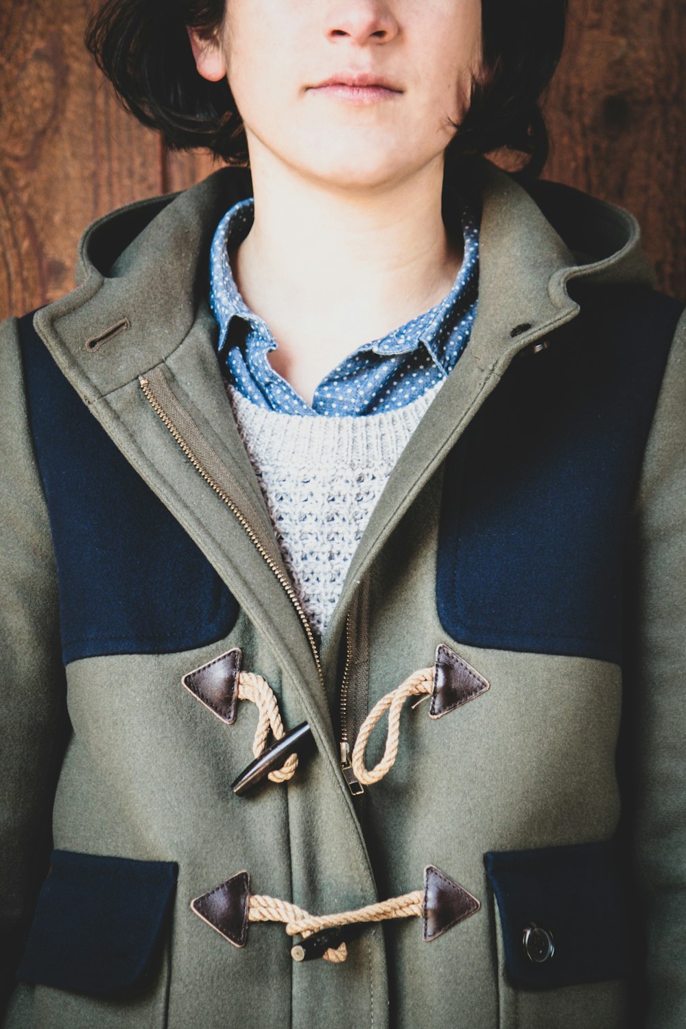 person in gray and blue coat