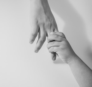 grayscale photo of to hands