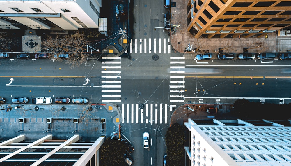 bird's eye photography of vehicles on road near building structures