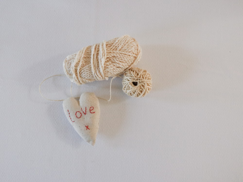 beige yarn and white love heart plush toy