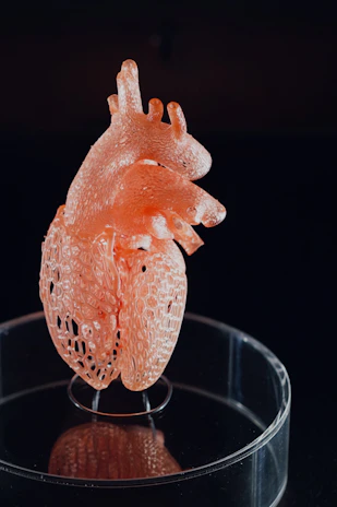 A detailed 3D animation still showing a medical device in action within the human body.