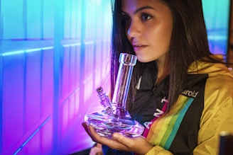 woman holding clear glass bong