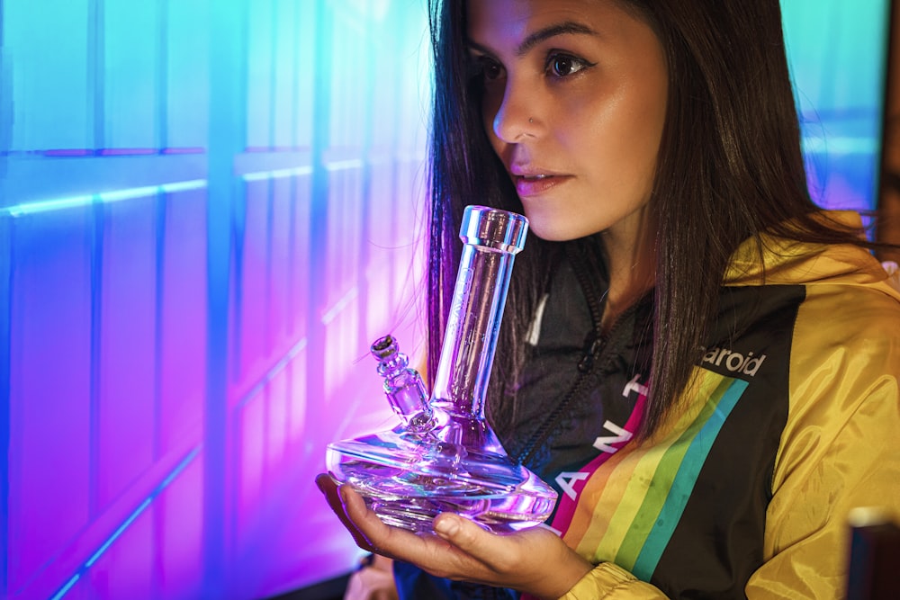 woman holding clear glass bong