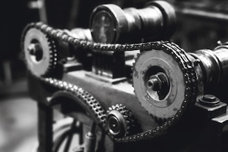 A stark, high-contrast image of a precise mechanical gear system symbolizing the human engine.