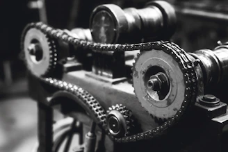 Industrial-style photo of Eaton Fuller transmission gears arranged on a dark metal surface with orange accents.