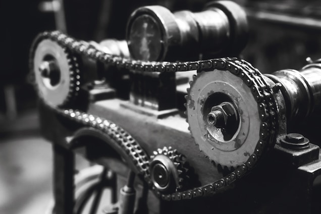 A clean, minimal photo of industrial machinery components arranged neatly against a white background.