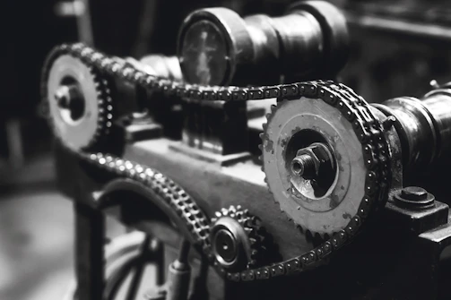 Industrial-style photo of Eaton Fuller transmission gears arranged on a dark metal surface with orange accents.