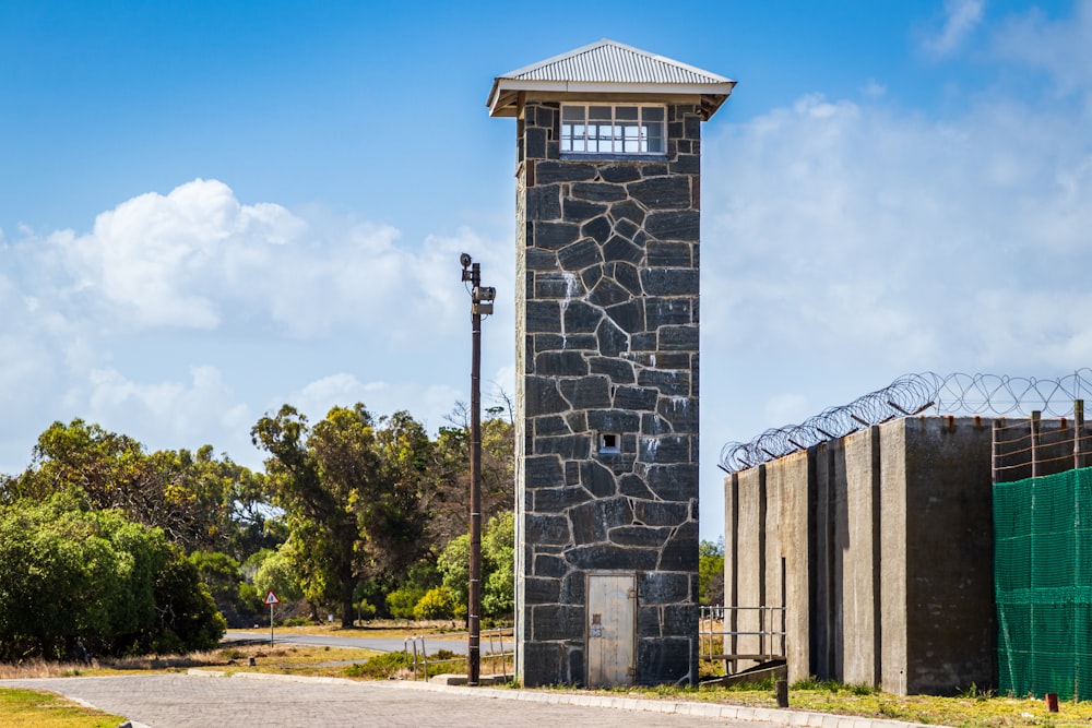 tower beside fence and road during day